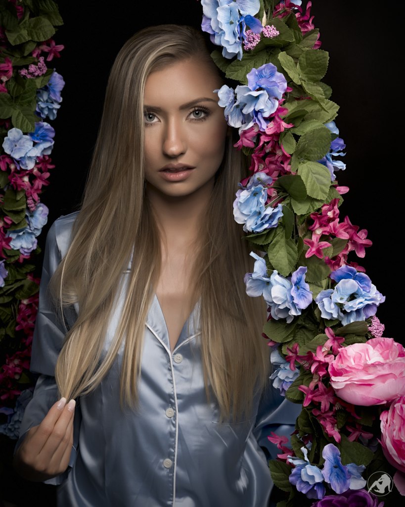 Beauty portrait in blue satin framed by flowers, photographed by Daring Leaderman