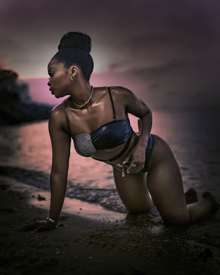 Swim portrait crouched on the shoreline at dusk