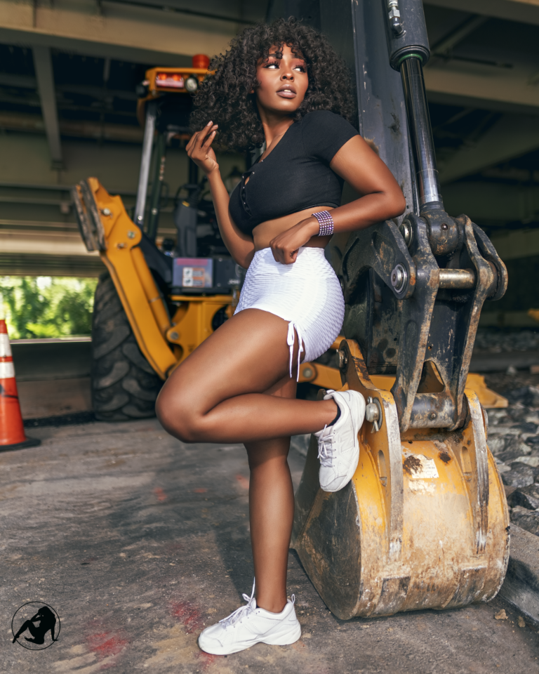 Fashion portrait posed on yellow construction machinery